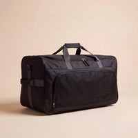 Black duffel bag on a beige background