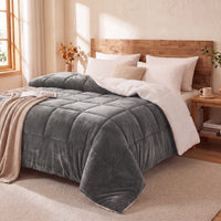 Gray teddy sherpa ultra warm doona on a bed in a cozy bedroom with wooden headboard and side tables.