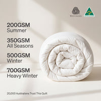 Roll of quilt with GSM weight information and Woolmark logo on a light background