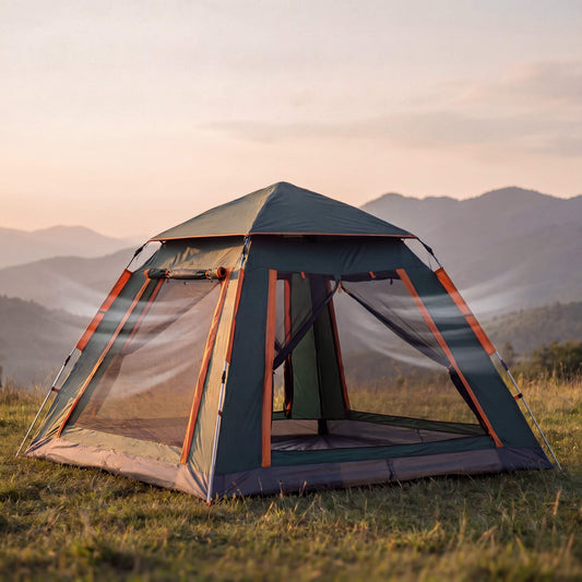 Camping tent in a grassy field with mountains in the background