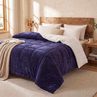 Bedroom with a bed featuring a purple teddy sherpa doona pillows and wooden headboard.
