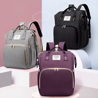 Three backpacks in gray, black, and purple on a colorful background