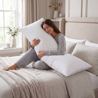 Woman holding a pillow in a bedroom setting