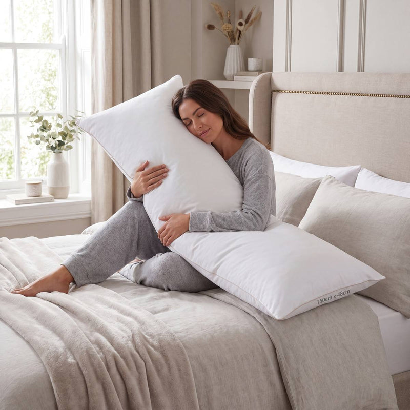 Woman holding a pillow in a bedroom setting