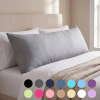 Gray pillow on a bed with color swatches at the bottom