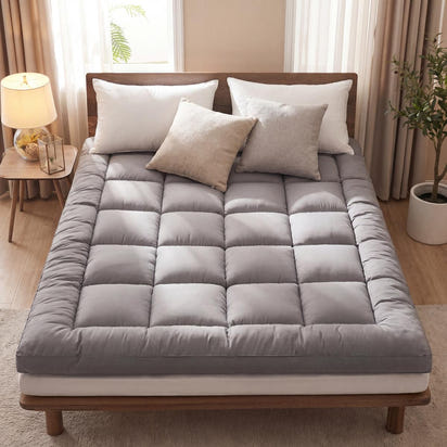 Gray mattress cover on a bed with pillows in a bedroom setting
