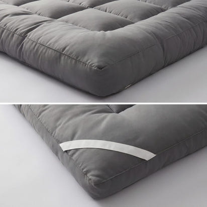 Gray mattress topper on a light gray background