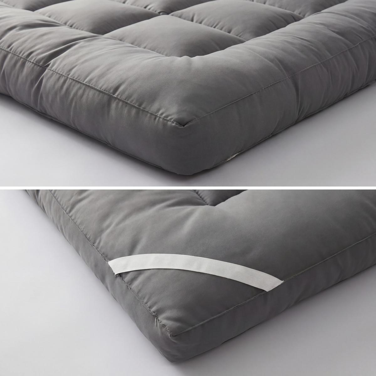 Gray mattress topper on a light gray background