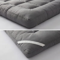 Gray mattress topper on a light gray background