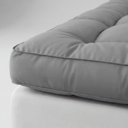 Gray cushion on a white surface
