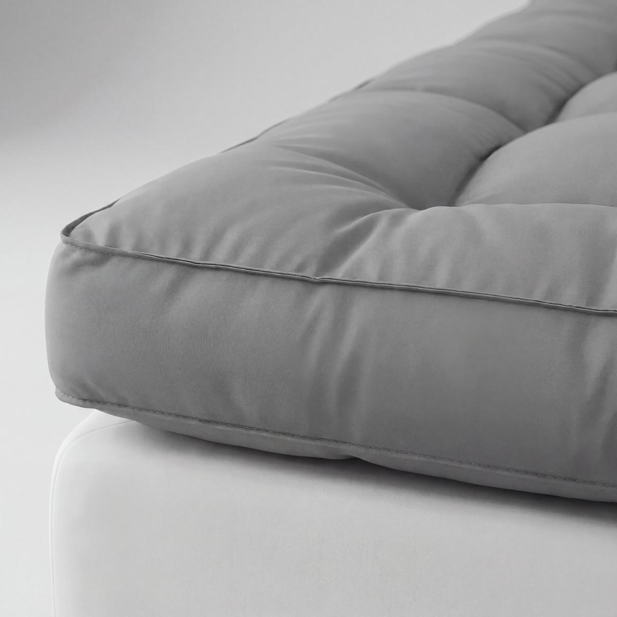 Gray cushion on a white surface