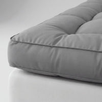 Gray cushion on a white surface