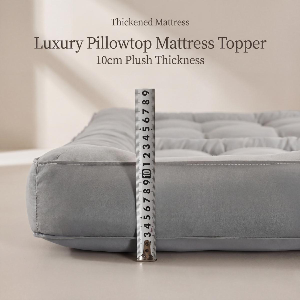 Gray luxury pillowtop mattress topper with a ruler for scale on a neutral background