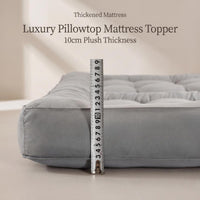 Gray luxury pillowtop mattress topper with a ruler for scale on a neutral background